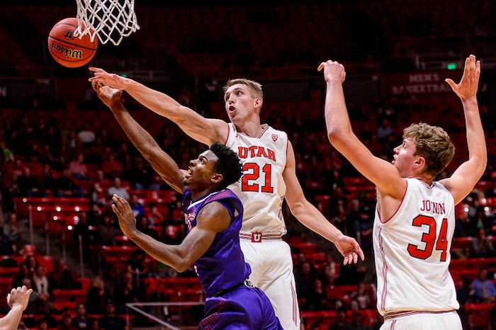 (Trent Nelson | The Salt Lake Tribune)  Utah Utes forward Tyler Rawson (21) blocks a shot by Northwestern State Demons guard Iziahiah Sweeney (1) as the University of Utah hosts Northwestern State, NCAA basketball in Salt Lake City, Wednesday December 20, 2017.