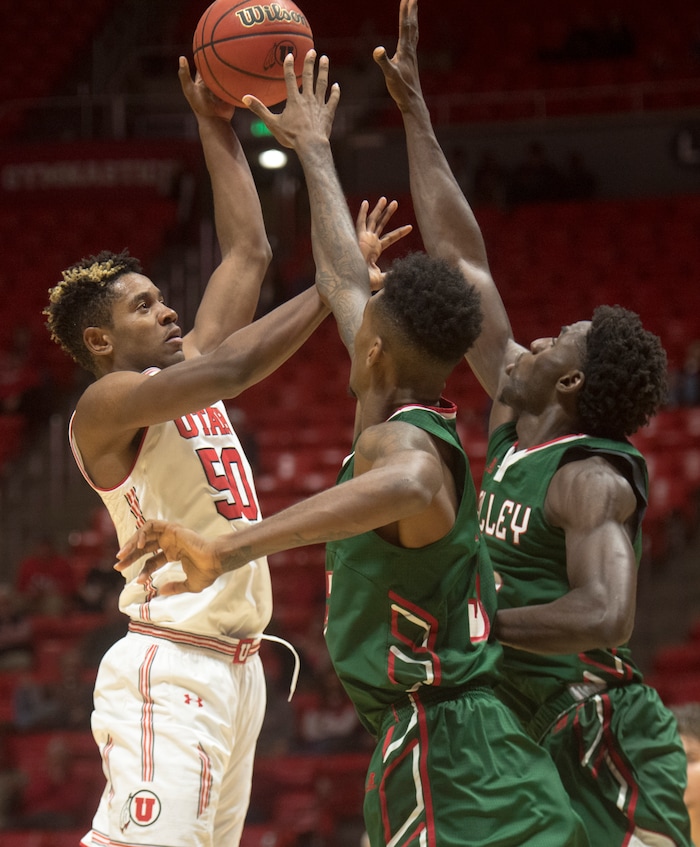 (Rick Egan  |  The Salt Lake Tribune)  Utah Utes guard Christian Popoola (50) shoots over Mississippi Valley State Delta Devils defenders, in basketball action Utah Utes vs. Mississippi Valley State Delta Devils, at the Jon M. Huntsman Center,  Monday, November 13, 2017.