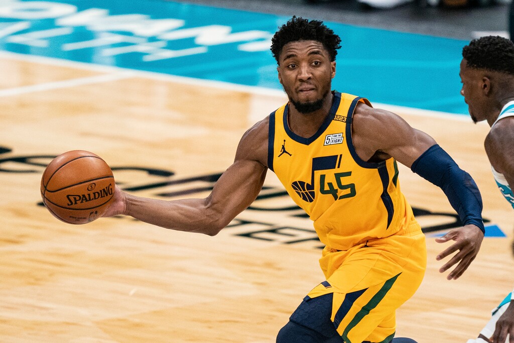 Utah Jazz guard Donovan Mitchell (45) passes the ball while guarded by Charlotte Hornets guard Terry Rozier during the second half of an NBA basketball game in Charlotte, N.C., Friday, Feb. 5, 2021. (AP Photo/Jacob Kupferman)
