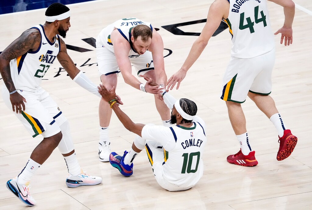 (Leah Hogsten | The Salt Lake Tribune) Utah Jazz forward Royce O'Neale (23),Utah Jazz guard Joe Ingles (2) and Utah Jazz forward Bojan Bogdanovic (44) help Utah Jazz guard Mike Conley (10) off the deck after a foul as the Utah Jazz take on the Memphis Grizzlies during Game 1 of the first-round playoffs at Vivint Arena, May 23, 2021.