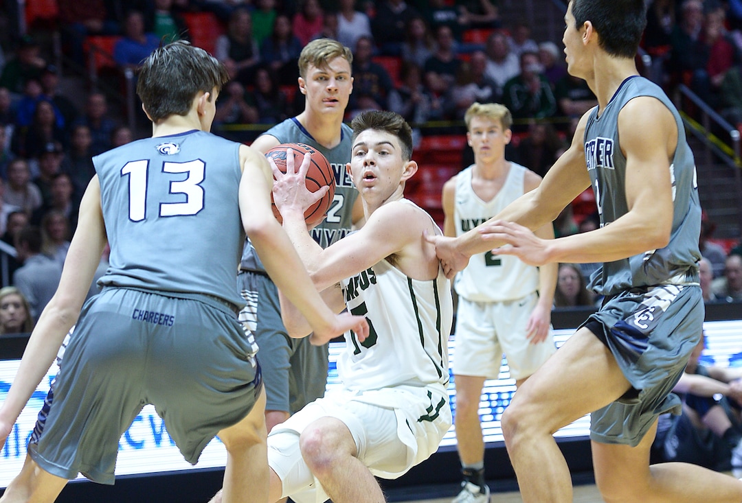 (Leah Hogsten  |  The Salt Lake Tribune) Olympus' Rylan Jones (15) is pressured by Corner Canyon's defense. Olympus plays Corner Canyon for the 5A High School BoysÕ Basketball Tournament Championship at the Jon M. Huntsman Center in Salt Lake City,  Saturday, March 3, 2018.