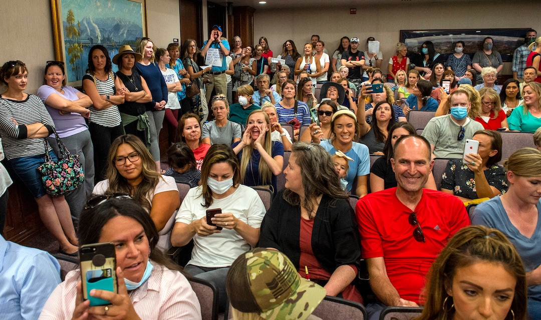 (Rick Egan  |  The Salt Lake Tribune)    Angry residents holler at the two remaining commissioners, when the Utah County Commission meeting was adjourned before it even started. The group protesting against masks being required in schools removed the social distancing tape on the chairs and filled the Utah County Commission room to over flowing, prompting Commissioner Tanner Ainge to call for a vote to adjourn the meeting in Provo, on Wednesday, July 15, 2020.