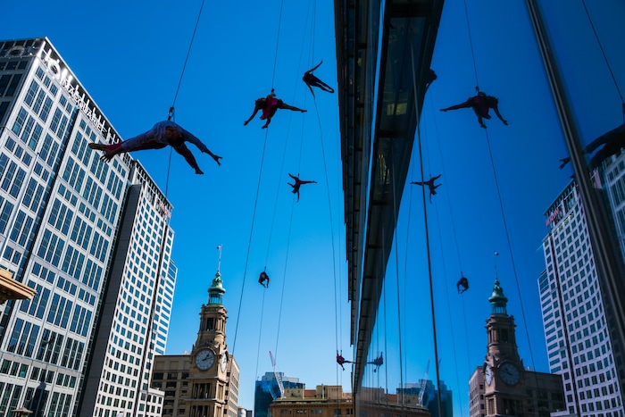 (Photo courtesy of Basil Tsimoyianis) Oakland, Calif.-based “vertical dance” company BANDALOOP performs in Sydney, Australia. They will be appearing at the Utah Arts Festival June 21-24, and will perform twice daily (5:30 and 7 p.m.) on the six-story library glass wall above the reflecting pool.