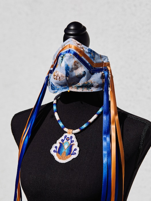 (Adam Amengual | The New York Times) A Navajo-inspired PPE mask and necklace created by Brighid Pulskamp is displayed in La Habra, Calif., on May 14, 2020. The mask and necklace will be auctioned for the UCLA American Indian Alumni Association’s scholarship fund.