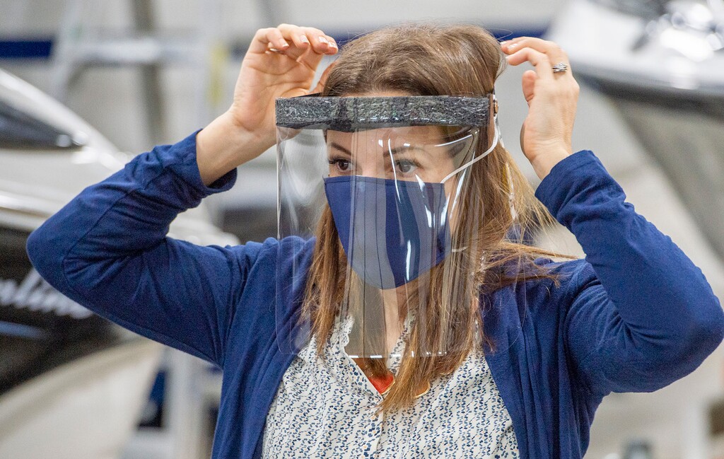 (Rick Egan  |  The Salt Lake Tribune)  Romy Humphries, director of marketing and sales at SugarHouse Industries in Midvale, demonstrates the face mask and face shields they are producing to protect healthcare professionals treating the coronavirus, Thursday, March 26, 2020.