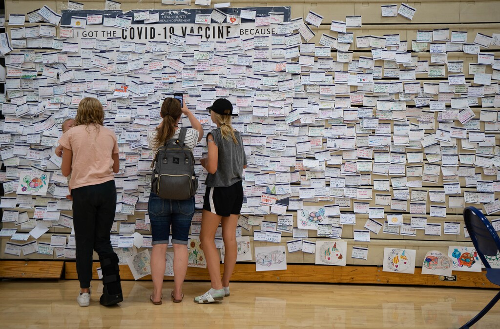 (Francisco Kjolseth | The Salt Lake Tribune) Folded-up bleachers at the old Provo High School gym are covered in notes accumulated since April by people giving their reasons for getting the COVID-19 vaccine as health care representatives administer the vaccine nearby on Wednesday, July 28, 2021.