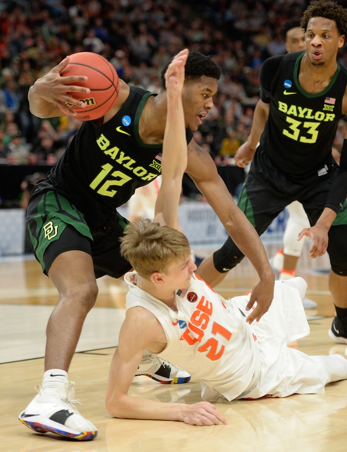 (Francisco Kjolseth  |  The Salt Lake Tribune)  Baylor Bears guard Jared Butler (12) and Syracuse Orange forward Marek Dolezaj (21) scramble for a ball as Syracuse faces Baylor in their first round men's NCAA March Madness tournament game at Vivint Smart Home Arena in Salt Lake City on Thursday, March 21, 2019.
