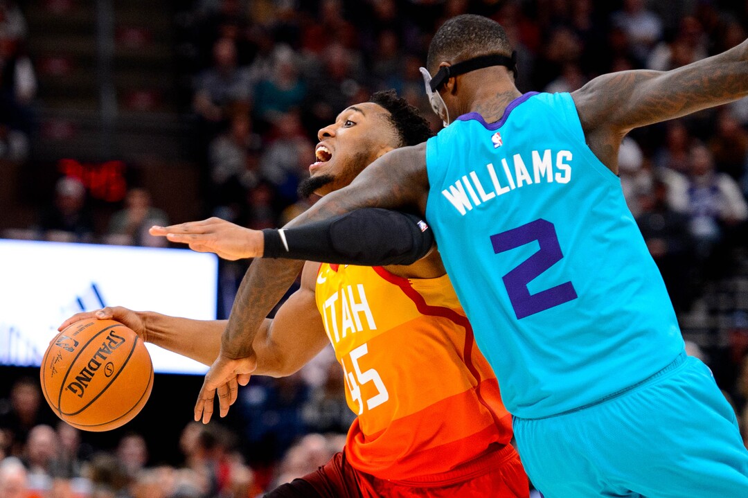 (Trent Nelson  |  The Salt Lake Tribune) Utah Jazz guard Donovan Mitchell (45) tangles with Charlotte Hornets forward Marvin Williams (2) as the Utah Jazz host the Charlotte Hornets, NBA basketball in Salt Lake City on Friday, Jan. 10, 2020.