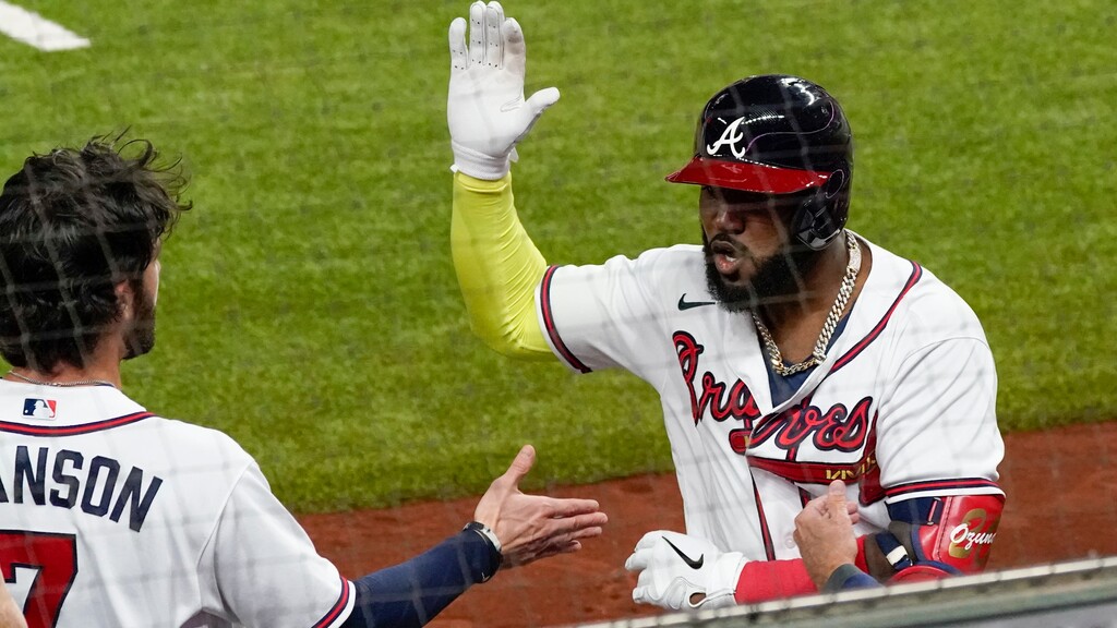 Atlanta Braves' Marcell Ozuna celebrates after a home run against the Los Angeles Dodgers during the fourth inning in Game 4 of a baseball National League Championship Series Thursday, Oct. 15, 2020, in Arlington, Texas. (AP Photo/Tony Gutierrez)