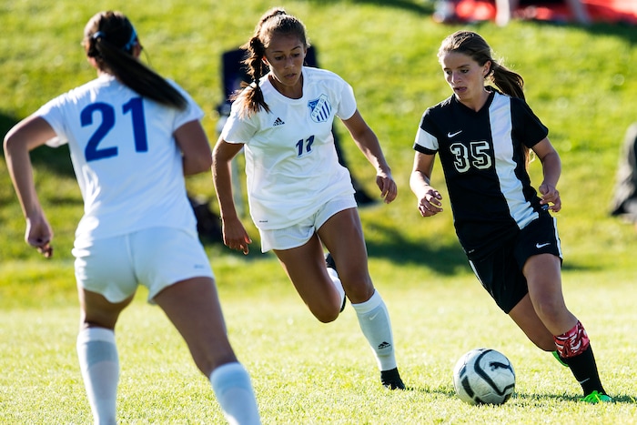 (Chris Detrick | The Salt Lake Tribune) Syracuse's Caroline Stringfellow (35) runs past Fremont's Karlie Valdez (11) during the game at Fremont High School Thursday, October 5, 2017.