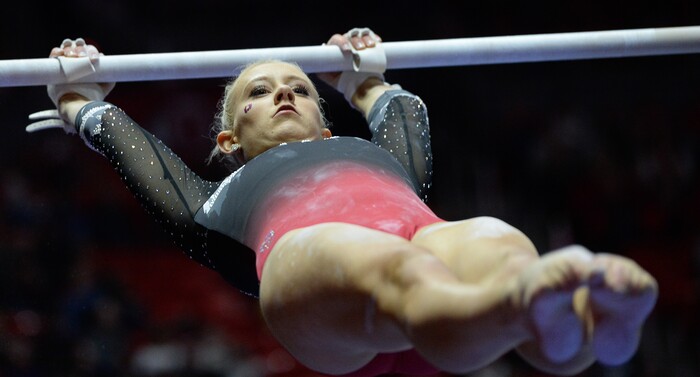 (Francisco Kjolseth  |  The Salt Lake Tribune)  Makenna Merrill-Giles performs her routing on the bars Utah hosts Penn State in their season opener at the Huntsman Center in Salt Lake City on Saturday, Jan. 5, 2019.