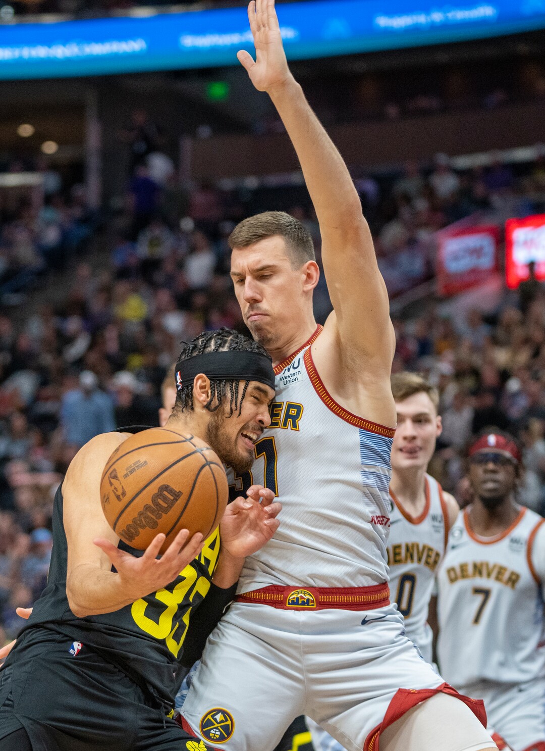 (Rick Egan | The Salt Lake Tribune) in Utah Jazz forward Jarrell Brantley (95) runs into Denver Nuggets guard Christian Braun (0) defends, in NBA action between the Utah Jazz and the Denver Nuggets at Vivint Arena,  Saturday, April 8, 2023.