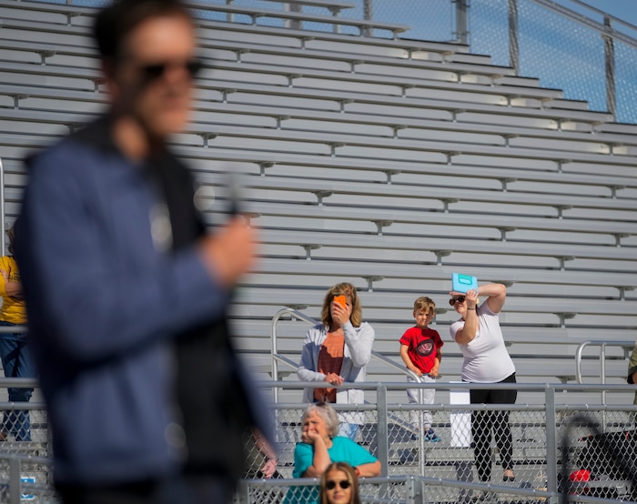 (Bethany Baker | The Salt Lake Tribune) People watch from the stands as Kevin Bacon speaks at a charity event to commemorate the 40th anniversary of the movie "Footloose" on the football field of Payson High School in Payson on Saturday, April 20, 2024.