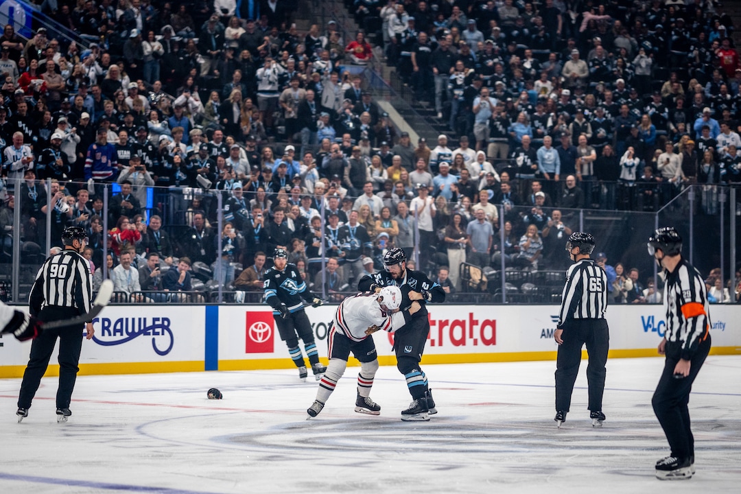 (Trent Nelson  |  The Salt Lake Tribune) Utah Mammoth defenseman MacKenzie Weegar (52) slugs Chicago Blackhawks center Ryan Donato (8) as the Utah Mammoth host the Chicago Blackhawks, NHL hockey in Salt Lake City on Thursday, Oct. 1, 2026.