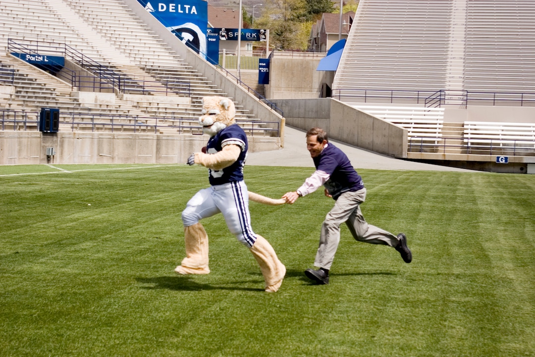 (Tribune file photo)  Provo Mayor John R. Curtis grabs Brigham Young University mascot Cosmo Cougar's tail at LaVell Edwards Stadium Friday May 7, 2010. Playing with Cosmo was one of many activities Curtis did on his 50th birthday to debunk a website's declaration that Provo was the least-fun city in America.