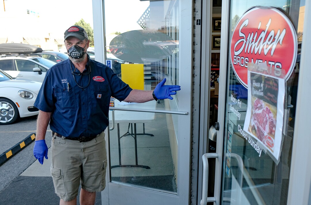 (Francisco Kjolseth  |  The Salt Lake Tribune) Will Wilson, co-owner of Snider Brothers Meats in Cottonwood Heights controls the flow of customers to his store on Tuesday, May 5, 2020, where he has been requiring that all customers wear masks or facial coverings when they come to shop due to the coronavirus pandemic.