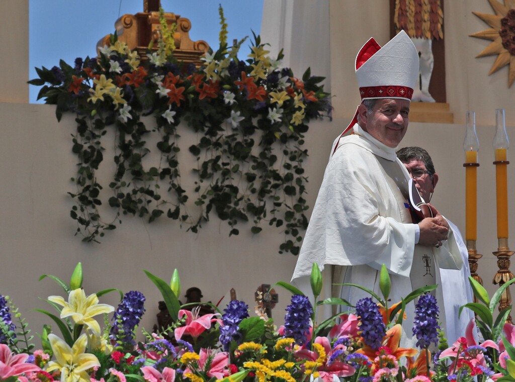 (AP Photo/Alessandra Tarantino, File) In this Jan. 18, 2018 photo,  Juan Barros, Bishop of Osornos, smiles as he leaves the altar at the end of a Mass celebrated by Pope Francis on Lobito Beach in Iquique, Chile. The pope's remarks defending Barros during his January visit drew shock from Chileans and immediate rebuke from victims and advocates worldwide, prompting him to later send the Vatican's sex crimes investigator to investigate Barros, who is accused of helping to cover up the sex crimes of pedophile priest Rev. Fernando Karadima.