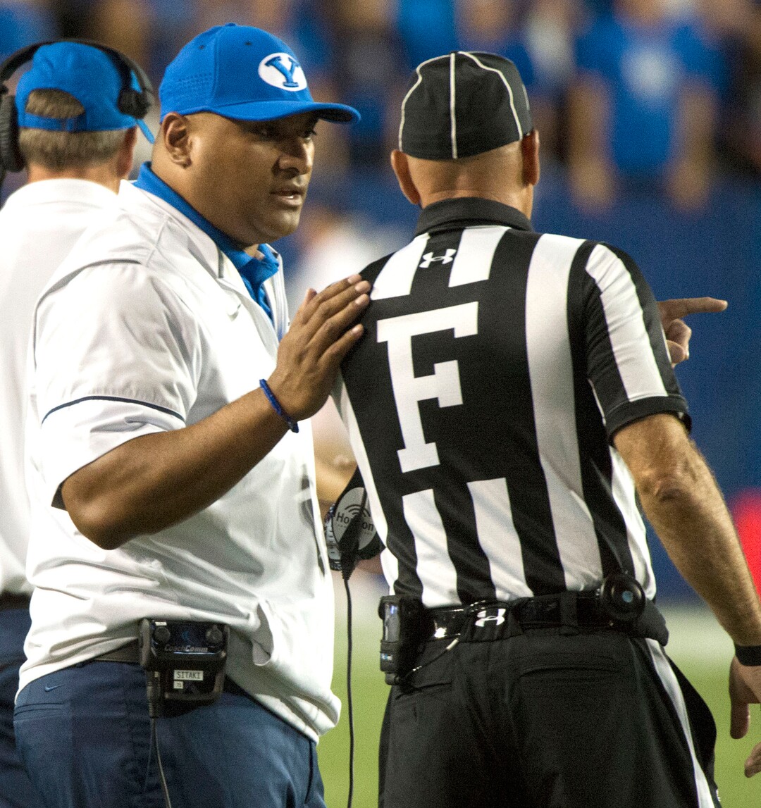 (Rick Egan  |  The Salt Lake Tribune)   Brigham Young Cougars head coach Kalani Satike talks to the official as he awaits the review of the targeting call, in football action BYU vs Utah, at Lavell Edwards Stadium in Provo, Saturday, September 9, 2017.