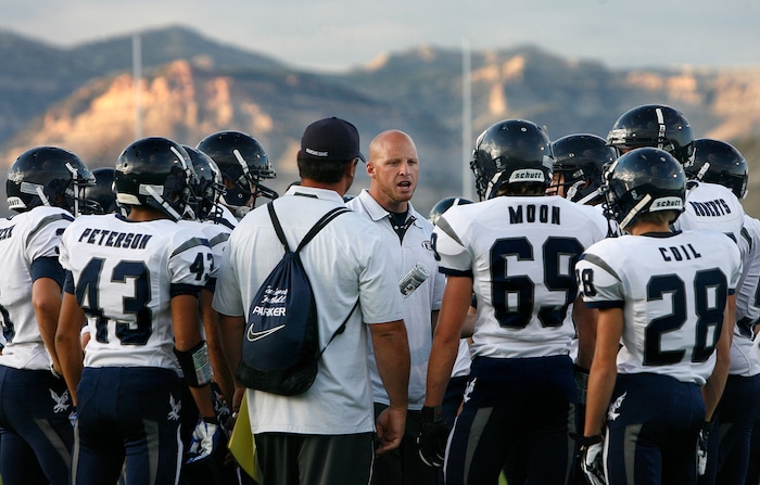 (Scott Sommerdorf   |  The Salt Lake Tribune) Duchesne head coach Jerry Cowan talks with his team after pre-game drills. The Eagles would go on to an easy 35-0 win against Carbon High which ran their winning streak to 37 games, setting the Utah state record for consecutive wins, Friday, September 6, 2013. 
