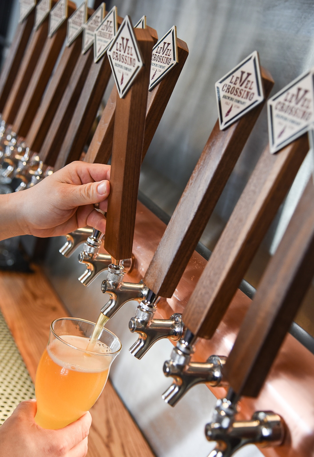 (Francisco Kjolseth  |  The Salt Lake Tribune)  Chris Detrick, head brewer for Level Crossing Brewing Co. pours one of four new beers on tap.