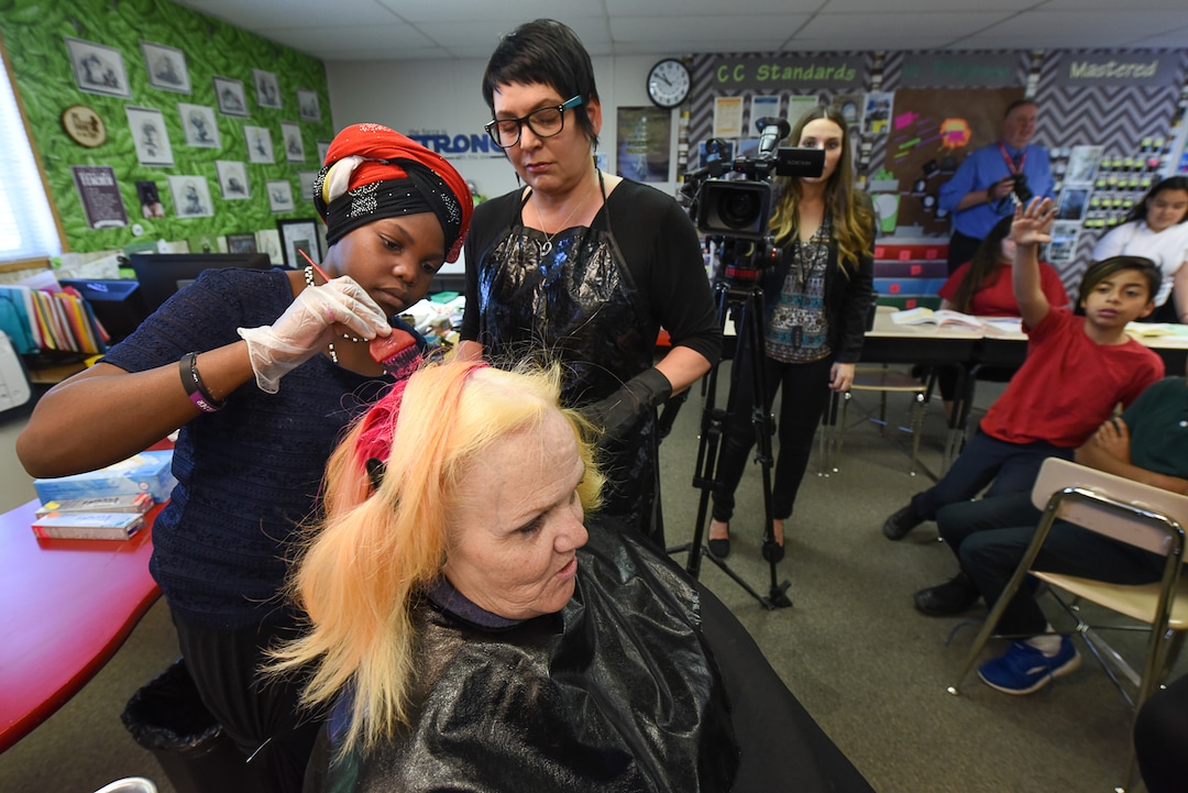 (Francisco Kjolseth  |  The Salt Lake Tribune)  Teachers are using creative ways to get kids SAGE scores up, including Sharon Moore, 6th grade teacher at North Star Elementary who agreed to dye her hair some wild colors as student Dehewo Dadiri, 12, gets a chance with the help of Merb Jones during class on Tuesday, May 8, 2018. This was the incentive that got her kids' scores up nearly 17 percent.