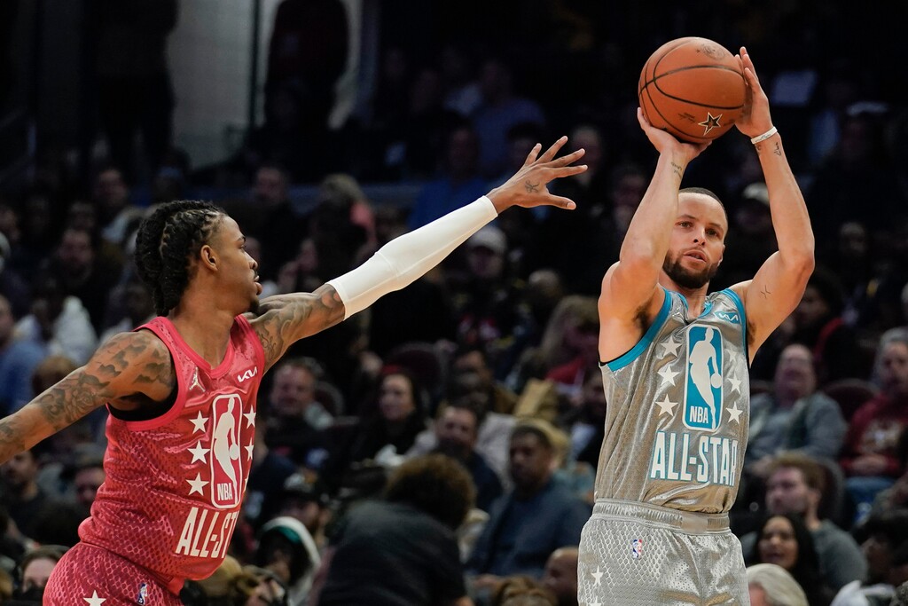 (AP Photo/Charles Krupa) Golden State Warriors' Stephen Curry, right, shoots for three as Memphis Grizzlies' Ja Morant defends during the second half of the NBA All-Star basketball game, Sunday, Feb. 20, 2022, in Cleveland.