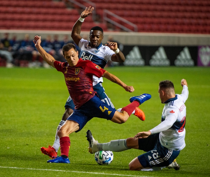 (Rick Egan  |  The Salt Lake Tribune)   Real Salt Lake defender Donny Toia (4) takes a shot as Vancouver Whitecaps forward Cristian Dajome (11) and Vancouver Whitecaps defender Jake Nerwinski (28) defend, in MLS soccer action between Real Salt Lake and the Vancouver Whitecaps at Rio Tinto Stadium on Saturday, Sept. 19, 2020.

 
 