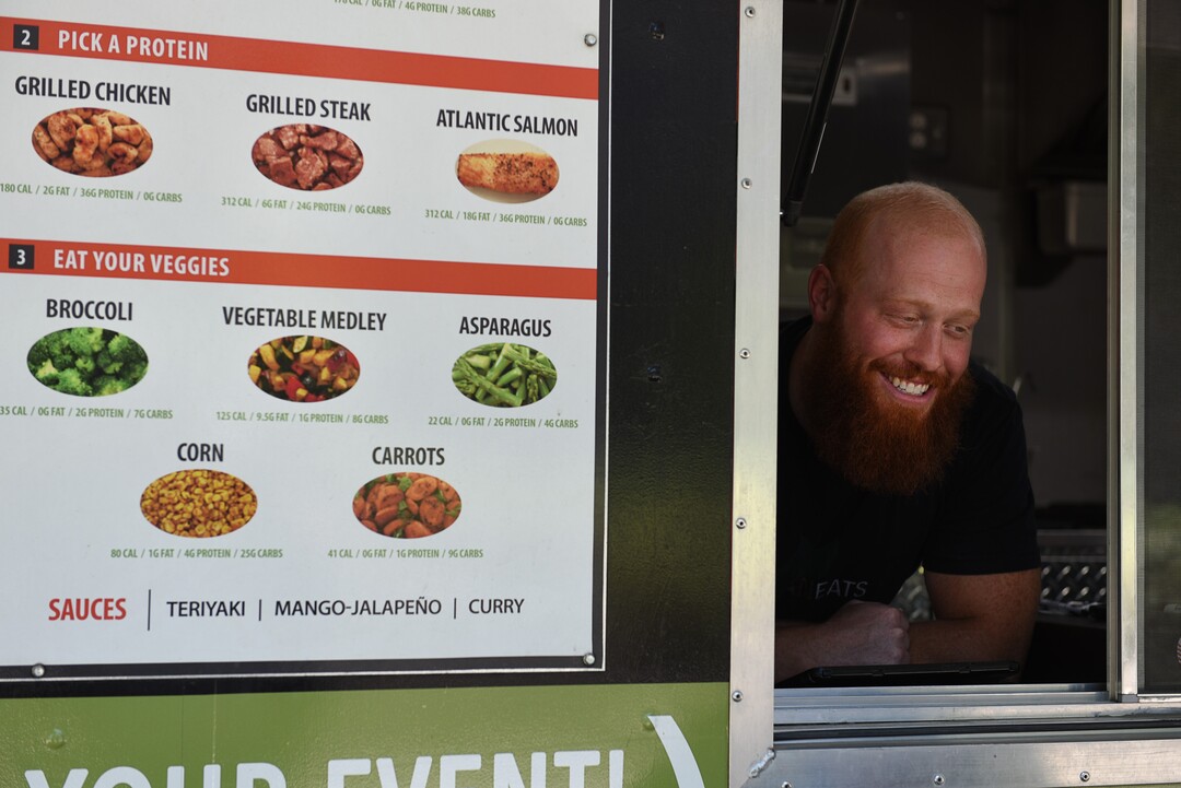 (Francisco Kjolseth  |  The Salt Lake Tribune)  Jared Trust takes orders from the Clean Eats food truck that serves health meals with lean proteins and fresh vegetables.