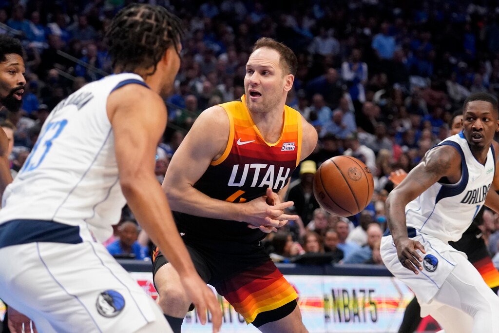 Utah Jazz forward Bojan Bogdanovic, center, loses control of the ball as Dallas Mavericks' Jalen Brunson, left, and Dorian Finney-Smith, right, defend in the first half of Game 2 of an NBA basketball first-round playoff series, Monday, April 18, 2022, in Dallas. (AP Photo/Tony Gutierrez)