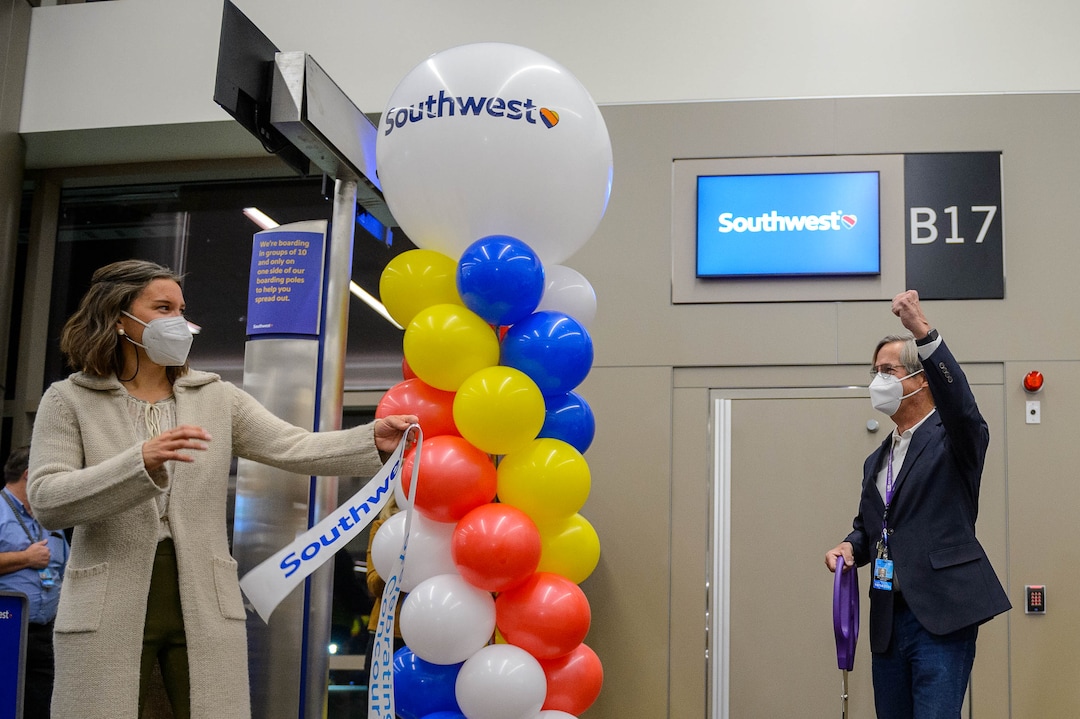 (Trent Nelson  |  The Salt Lake Tribune) airport director Bill Wyatt pumps his fist after cutting a ribbon at gate B17, opening concourse B at the Salt Lake City International Airport on Tuesday, Oct. 27, 2020. At left is Salt Lake City Mayor Erin Mendenhall.