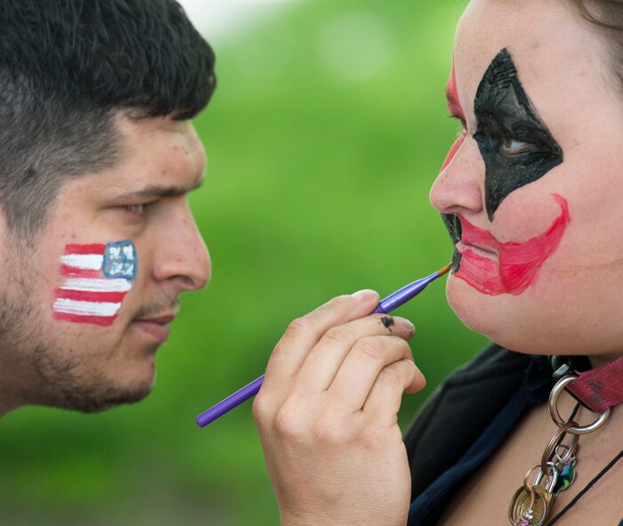 (Rick Egan  |  The Salt Lake Tribune)      
Bryan Lemoine paints Riley Hunter's face at Pioneer Park, as the Salt Lake City Mission fed and donated clothes to the homeless in Pioneer Park on Memorial day, Monday, May 28, 2018.


