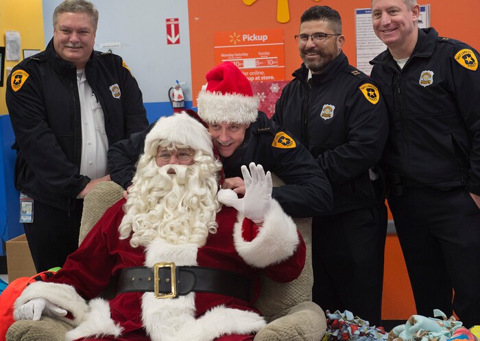 (Scott Sommerdorf   |  The Salt Lake Tribune)   Salt Lake City's Police Chief Mike Brown poses with Santa at the first ever Police Pay It Forward event, Saturday, December 16, 2017.  