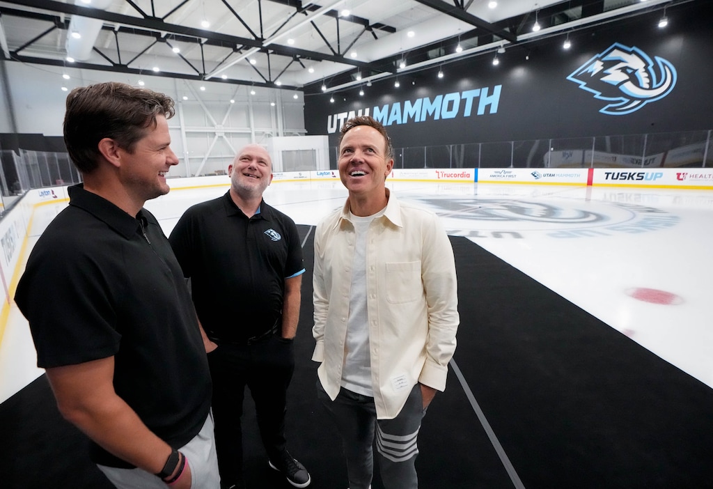(Francisco Kjolseth | The Salt Lake Tribune) Utah Jazz coach Will Hardy, left, and Utah Mammoth coach André Tourigny join owner Ryan Smith on the ice of the new Mammoth practice and training facility at the southeast end of The Shops at South Town in Sandy, during a soft opening celebration on Wed. Sept. 17, 2025.