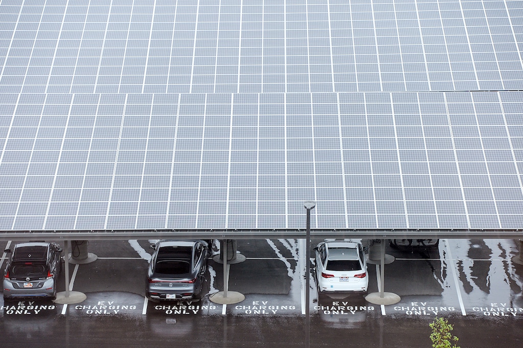 (Chris Samuels | The Salt Lake Tribune) Solar panels cover electric vehicle charging stations at the new Zions Technology Center in Midvale, Friday, July 15, 2022. The U.S. Senate has passed legislation that will extend the $7.500 tax credit for buyers of new electric vehicles and create a new $4,000 incentive for used electric vehicles.