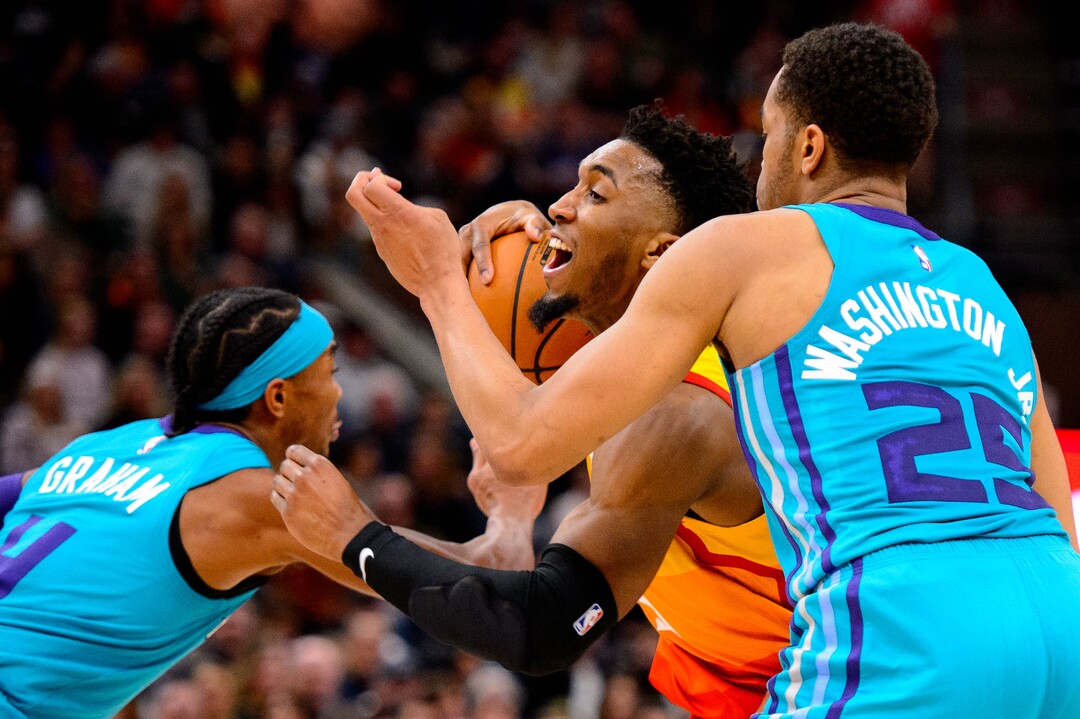 (Trent Nelson  |  The Salt Lake Tribune) Utah Jazz guard Donovan Mitchell (45) drives between Charlotte Hornets guard Devonte' Graham (4) and Charlotte Hornets forward PJ Washington (25) as the Utah Jazz host the Charlotte Hornets, NBA basketball in Salt Lake City on Friday, Jan. 10, 2020.