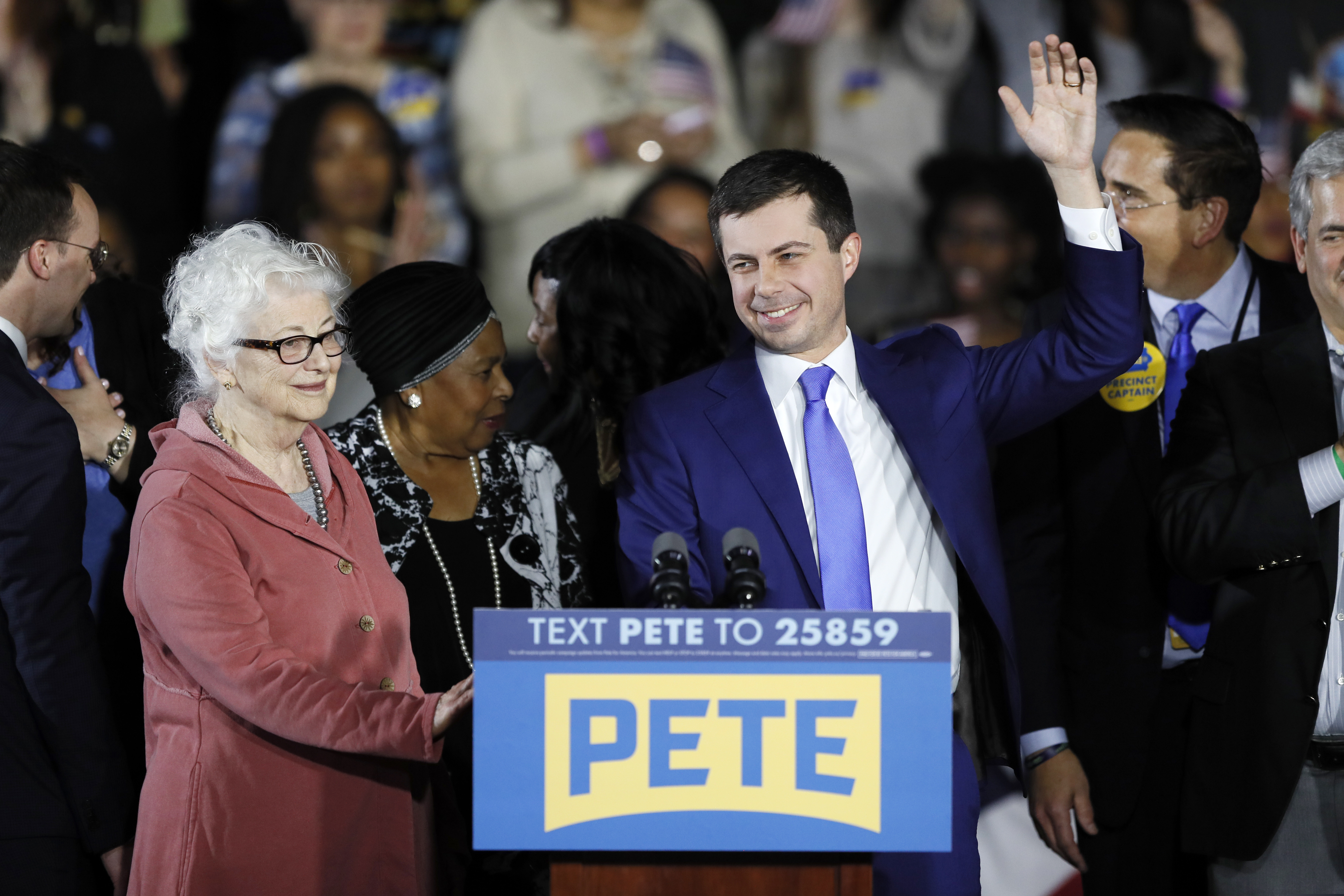 (Charlie Neibergall | AP) Democratic presidential candidate former South Bend, Ind., Mayor Pete Buttigieg and his mom Anne Montgomery, left, greet supporters at a caucus night campaign rally, Monday, Feb. 3, 2020, in Des Moines, Iowa.