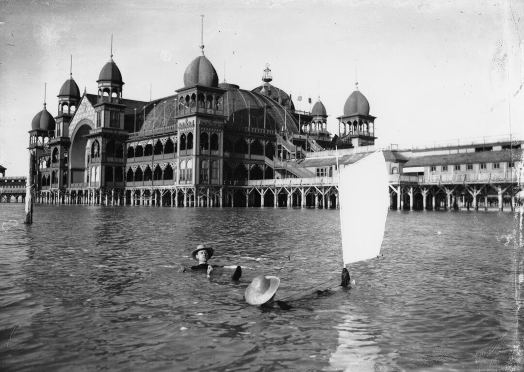 (Utah State Historical Society) Two men, one apparently hoping to set sail, entertain themselves in the purportedly medicinal salt water of the Great Salt Lake at Saltair in 1910. 