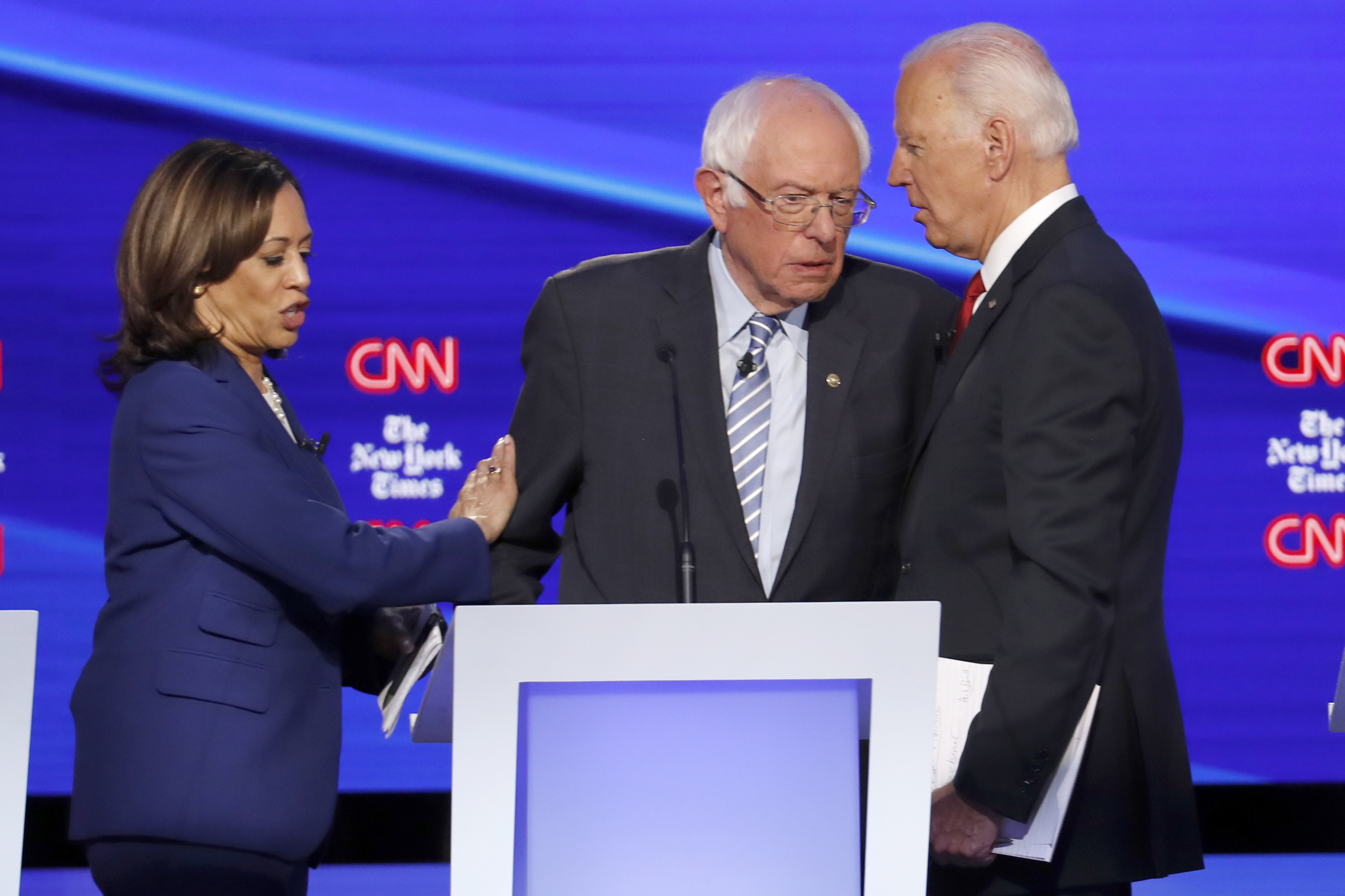 (John Minchillo | AP file photo) Democratic presidential candidate Sen. Kamala Harris, D-Calif., left, Sen. Bernie Sanders, I-Vt., middle, and former Vice President Joe Biden talk following a Democratic presidential primary debate hosted by CNN/New York Times at Otterbein University, Tuesday, Oct. 15, 2019, in Westerville, Ohio. Kamala Harris endorsed Joe Biden on Sunday, March 8, 2020, saying she would "do everything in my power'' to help elect him.