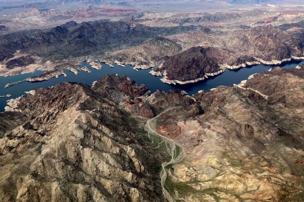 (John Locher | AP) A bathtub ring of light minerals show the high water mark on the shore of Lake Mead along the border of Nevada and Arizona, Monday, March 6, 2023, near Boulder City, Nev. The federal government is expected to make an announcement on Tuesday, Aug. 15, 2023, about the health of the Colorado River and water cuts in 2024.