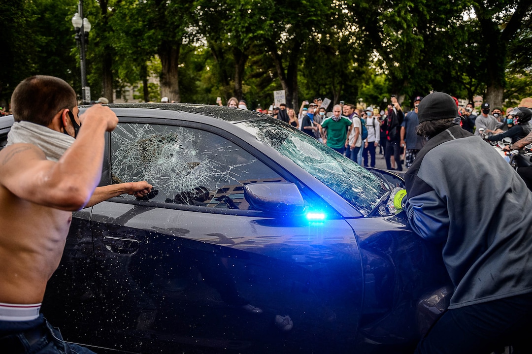 (Trent Nelson  |  The Salt Lake Tribune)  Protesters attacked an emergency vehicle and smashed the windows on Saturday, May 30, 2020.