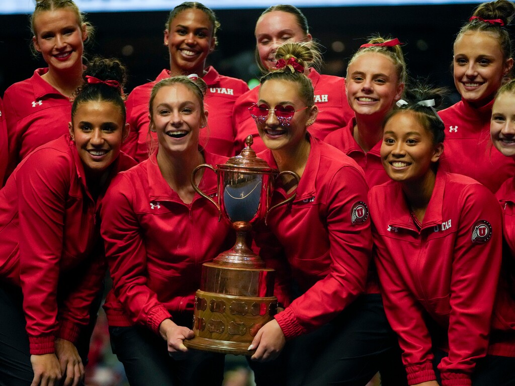 (Bethany Baker  |  The Salt Lake Tribune) Utah Red Rocks gymnastics poses with the trophy after winning the Best of Utah meet between Utah, BYU, Utah State and Southern Utah at Maverik Center in West Valley City on Monday, Jan. 15, 2024.