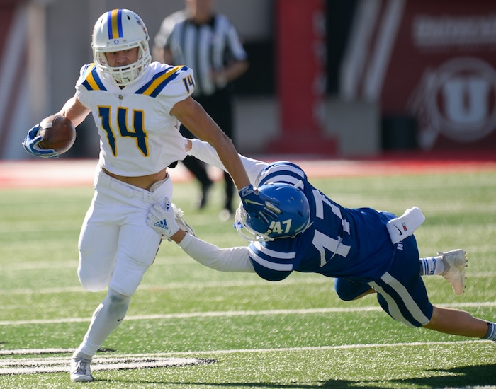 (Francisco Kjolseth  |  The Salt Lake Tribune)  Trevor Rockey of Orem gets past Harrison Beazer of Dixie in the 4A high school championship game at Rice Eccles Stadium in Salt Lake City, Friday, Nov. 16, 2018.