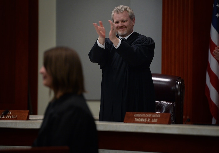(Scott Sommerdorf   |  The Salt Lake Tribune)   during the Supreme Court Justice John A. Pearce stands to applaud after Paige Petersen finished her remarks after her swearing in as the new Utah Supreme Court justice, Friday, January 19, 2018.