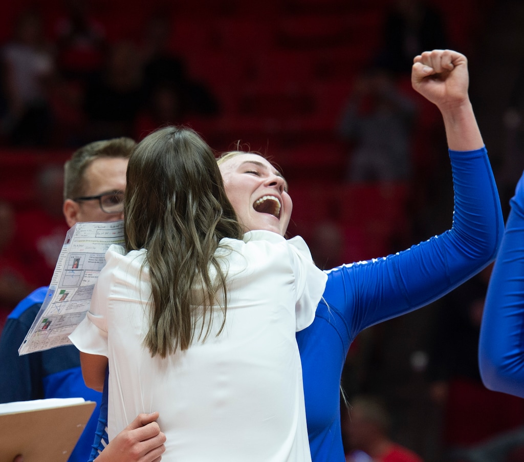 (Rick Egan  |  The Salt Lake Tribune)      McKenna Miller (14) hugs head coach Heather Olmstead as they celebrate the Cougars win over Utah, in volleyball action at the Jon M. Huntsman Center, Thursday, Sept. 19, 2019.