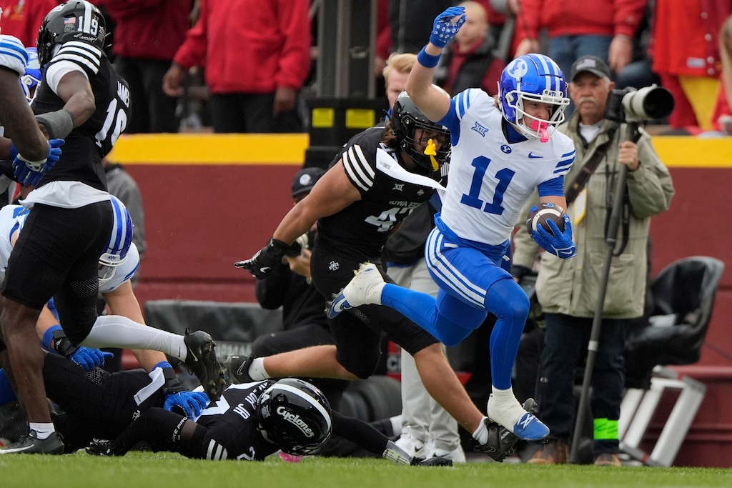 BYU wide receiver Parker Kingston (11) runs the ball as he gets free from Iowa State's defense during the first half of an NCAA college football game, Saturday, Oct. 25, 2025, in Ames, Iowa. (AP Photo/Matthew Putney)