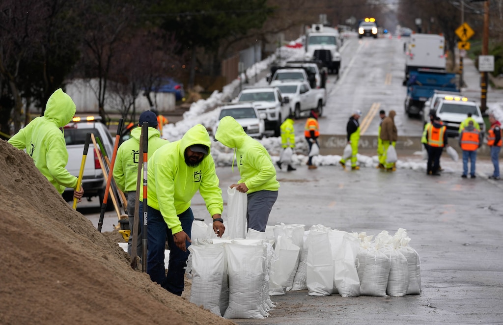 (Francisco Kjolseth | The Salt Lake Tribune) Crews continue to mitigate high water from Emigration Creek in Salt Lake City as they redirect water across 1700 South and back into the creek through Wasatch Hollow Park on Thursday, April 13, 2023.