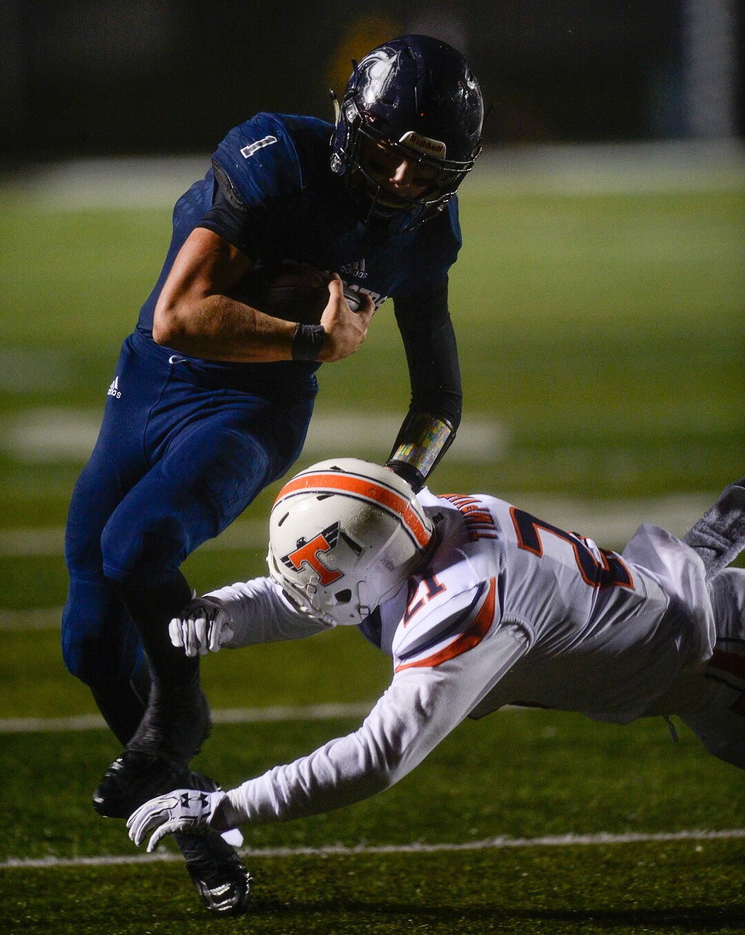 (Francisco Kjolseth  |  The Salt Lake Tribune)  Corner Canyon quarterback Zach Wilson runs the ball as the Timpview defense moves in during game action at Corner Canyon on Thursday, Sept. 21, 2017.