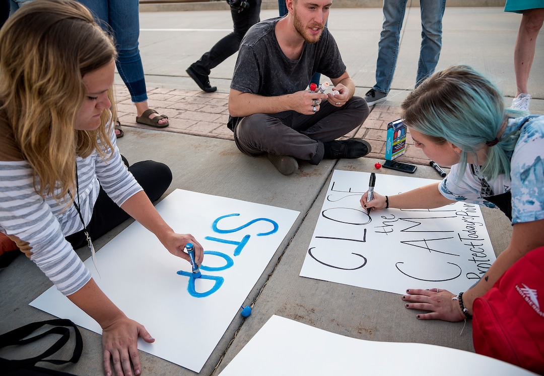 Michael Mangum  |  Special to the TribuneLaurel Peacock, left, Kade Carter, center, and Genevieve Smith make signs during a protest outside the U.S. Immigration and Customs Enforcement Salt Lake City Field Office in West Valley City, UT on Wednesday, July 24, 2019.