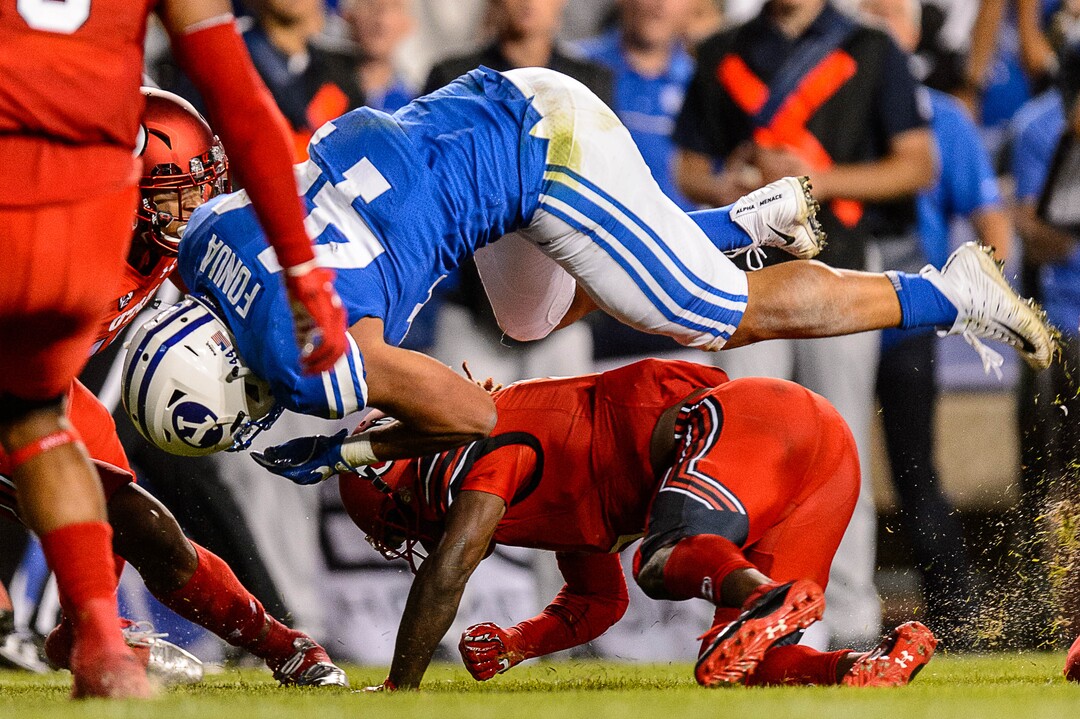 (Trent Nelson | The Salt Lake Tribune)  Brigham Young Cougars running back Kavika Fonua (44) leaps over Utah Utes defensive back Boobie Hobbs (1)as BYU hosts Utah, NCAA football in Provo, Saturday September 9, 2017.