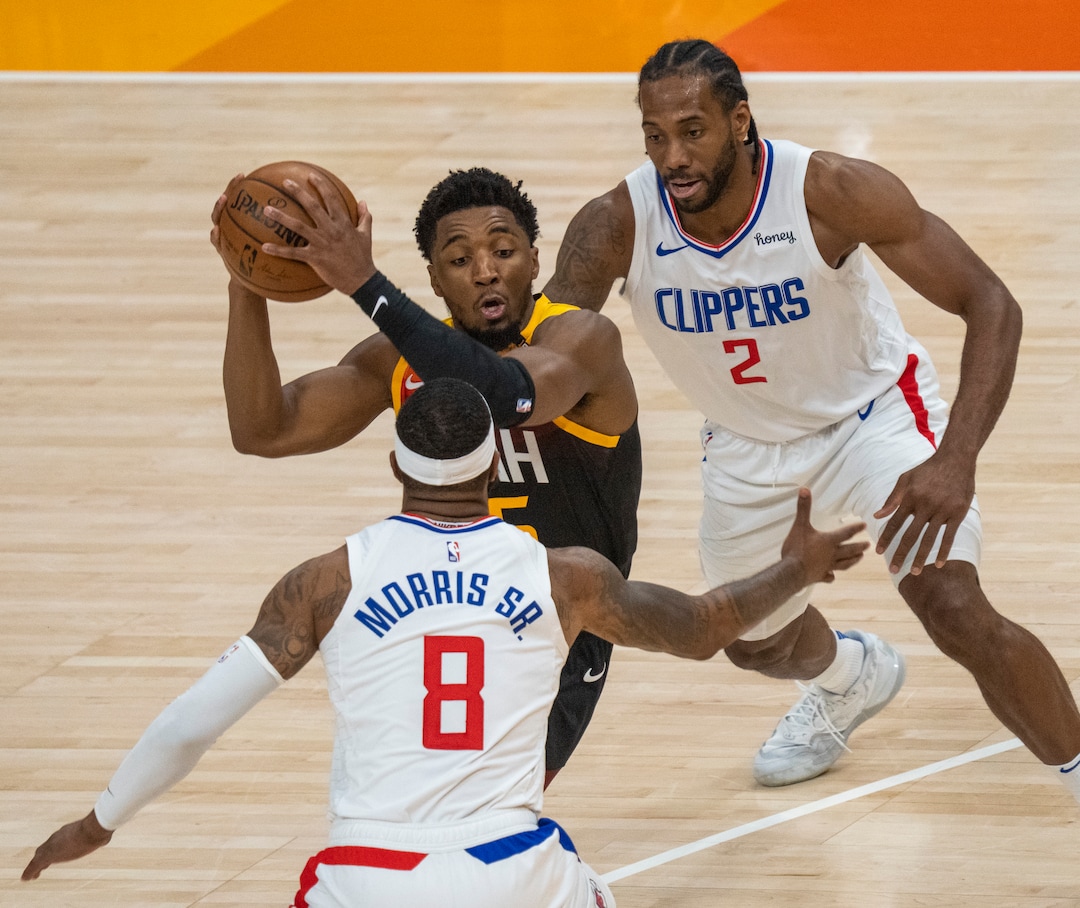 (Rick Egan | The Salt Lake Tribune) Donovan Mitchell (45) splits the LA defenders, forward Kawhi Leonard (2)] and Clippers forward Marcus Morris Sr. (8) to score for the Jazz, in NBA action between the Utah Jazz and the LA Clippers, in game one in the second round of the NBA playoff series at Vivint Arena, on Tuesday, June 8, 2021.